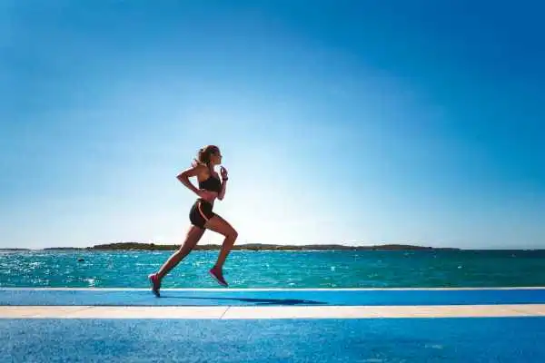 Woman running showing strong leg muscle Orrell